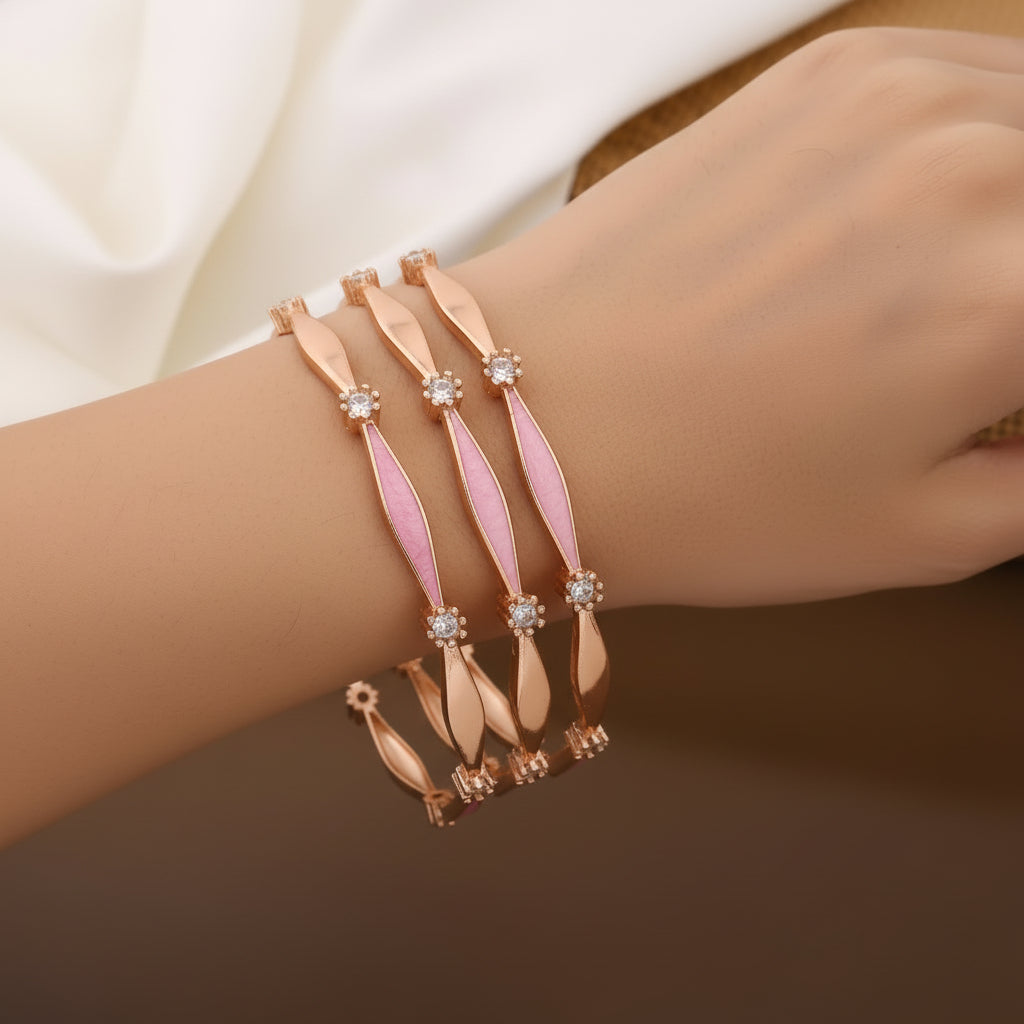 Bracelet with pink and rose gold design on a wrist against a neutral background