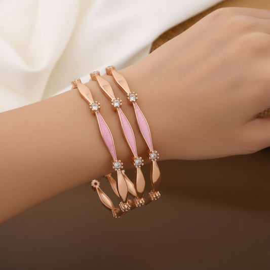 Bracelet with pink and rose gold design on a wrist against a neutral background
